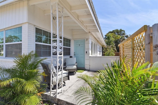 view of patio / terrace with fence and covered porch