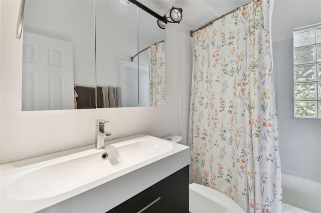 bathroom with shower / tub combo, toilet, and vanity