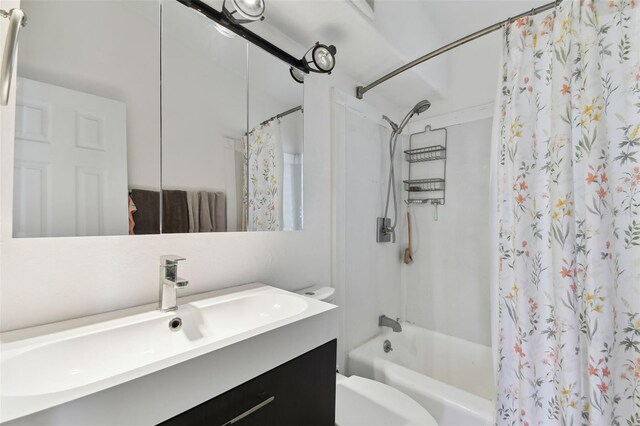 full bathroom with vanity, toilet, and shower / bath combo with shower curtain