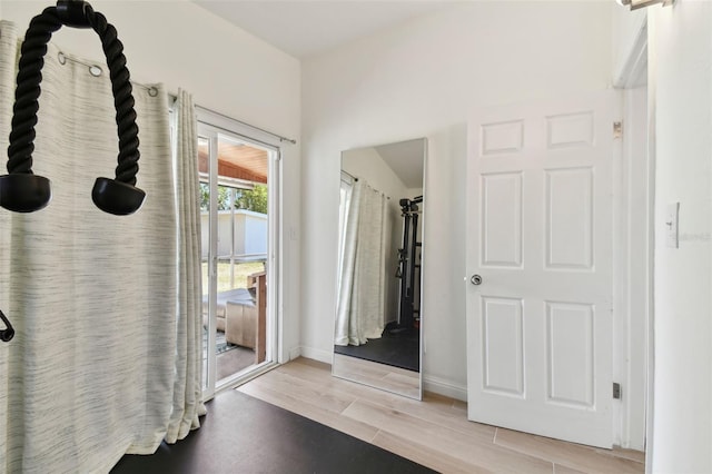 bathroom with baseboards and wood finish floors