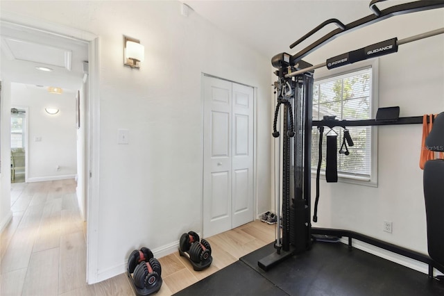 workout room with baseboards and wood finished floors
