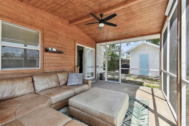 unfurnished sunroom with wooden ceiling, ceiling fan, and vaulted ceiling