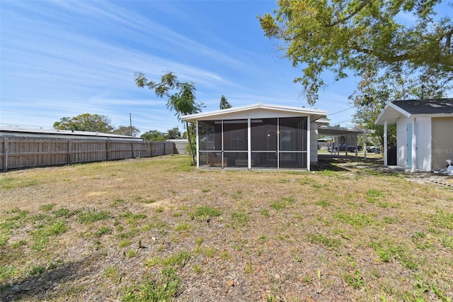 view of yard with fence and a sunroom
