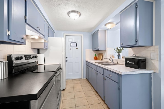 kitchen with electric range, light tile patterned floors, blue cabinetry, and a sink