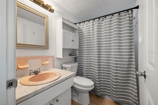 full bath with toilet, a textured ceiling, a shower with shower curtain, tile patterned flooring, and vanity