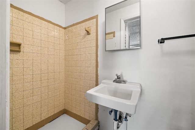 bathroom with a tile shower