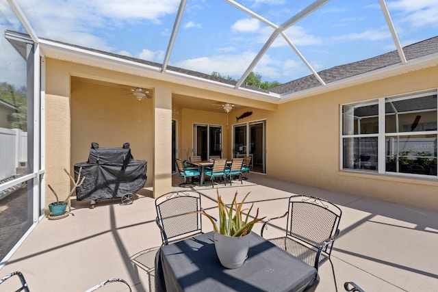 5123 Whispering Leaf Trl, Valrico, FL 33596 - view of patio / terrace with outdoor dining area, a ceiling fan, and glass enclosure