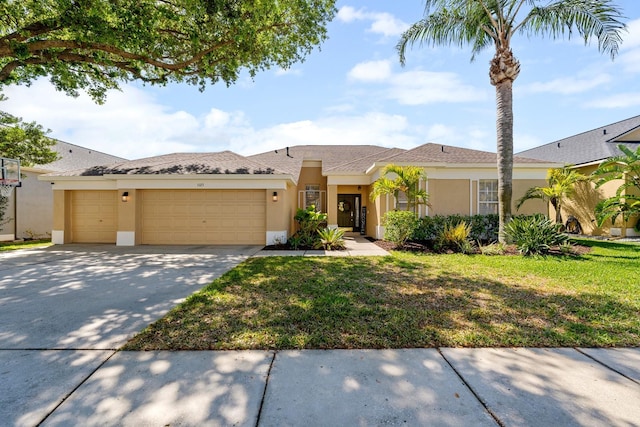 5123 Whispering Leaf Trl, Valrico, FL 33596 - view of front of house featuring stucco siding, a garage, driveway, and a front lawn