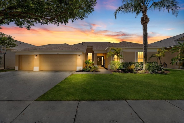 5123 Whispering Leaf Trl, Valrico, FL 33596 - view of front facade featuring stucco siding, a garage, driveway, a front lawn, and a shingled roof