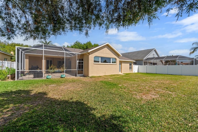 5123 Whispering Leaf Trl, Valrico, FL 33596 - back of house with stucco siding, glass enclosure, and a patio area
