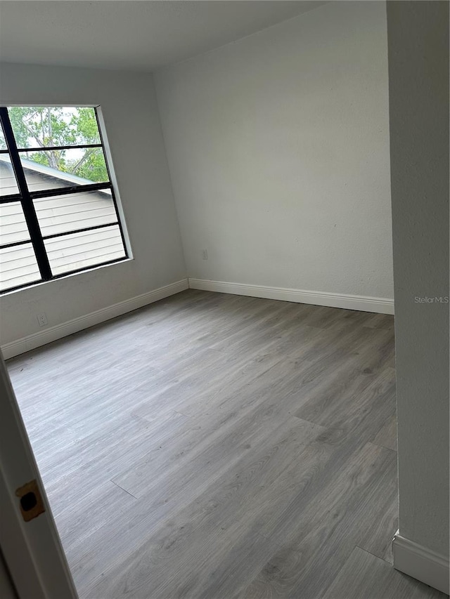 10216 N Pawnee Ave, Tampa, FL 33617 - spare room with baseboards and wood finished floors
