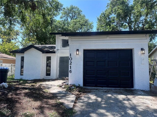 10216 N Pawnee Ave, Tampa, FL 33617 - view of front of property featuring concrete driveway and stucco siding