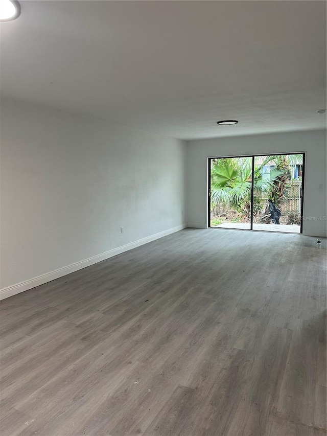 10216 N Pawnee Ave, Tampa, FL 33617 - spare room featuring wood finished floors and baseboards