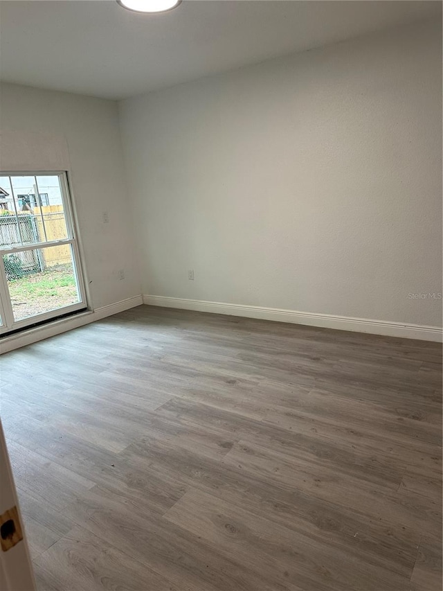 10216 N Pawnee Ave, Tampa, FL 33617 - spare room with wood finished floors and baseboards
