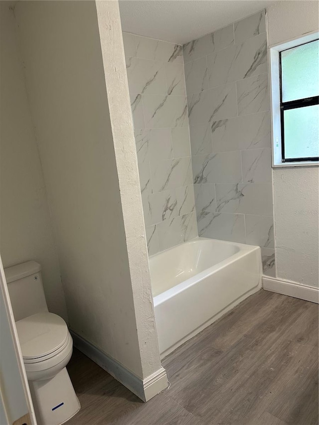 10216 N Pawnee Ave, Tampa, FL 33617 - bathroom featuring wood finished floors and shower / bath combination
