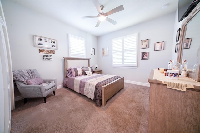 bedroom featuring baseboards, light carpet, and ceiling fan