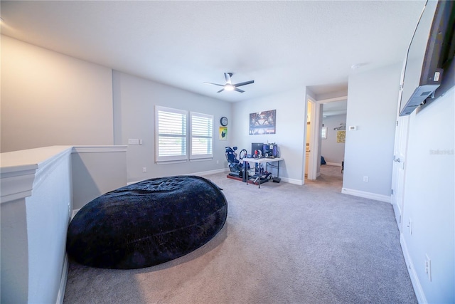 bedroom with baseboards, light carpet, and a ceiling fan