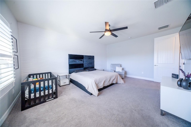 bedroom with visible vents, baseboards, ceiling fan, and carpet floors