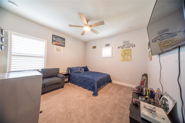 bedroom with multiple windows, carpet flooring, baseboards, and ceiling fan