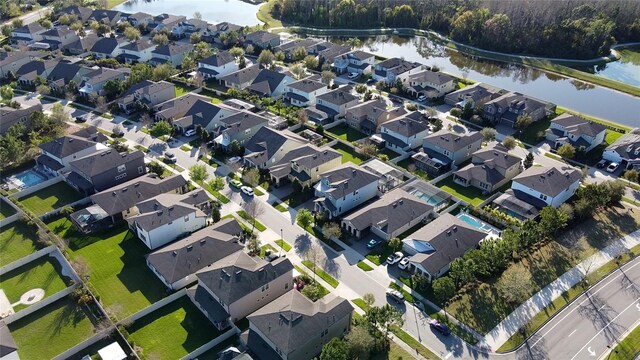 bird's eye view with a residential view and a water view