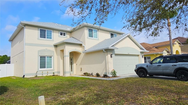 traditional home featuring stucco siding, fence, concrete driveway, a front yard, and an attached garage