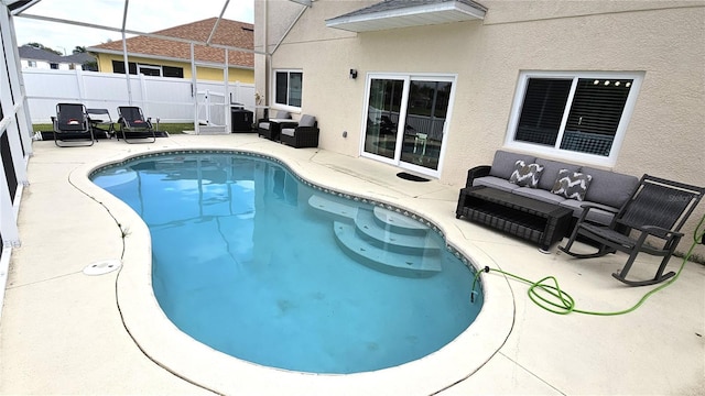 view of swimming pool with an outdoor living space, fence, a patio area, and a fenced in pool