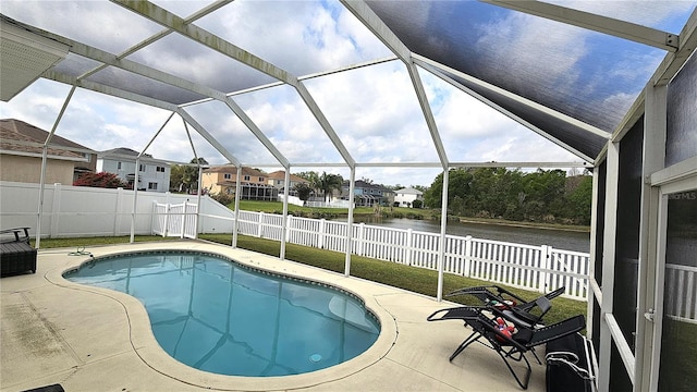 view of swimming pool with a fenced in pool, a patio, a fenced backyard, and a water view