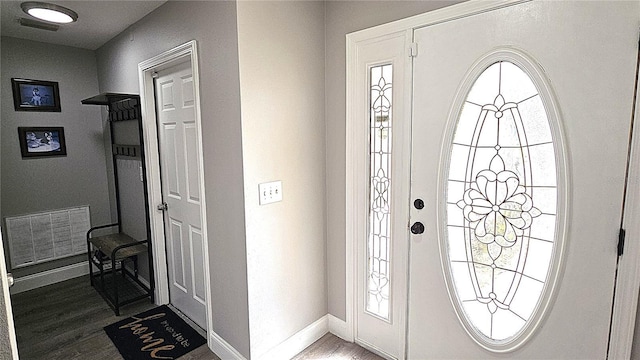 foyer with visible vents, baseboards, and wood finished floors