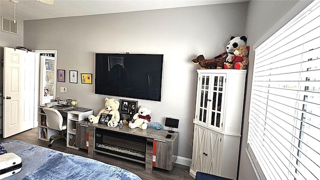 bedroom with visible vents and wood finished floors