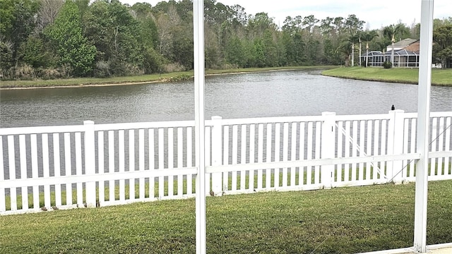 exterior space featuring fence and a water view