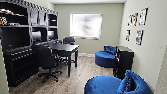 office featuring baseboards and light wood-style floors