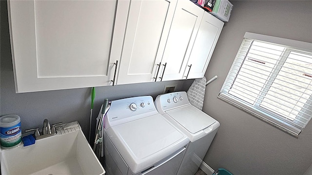 laundry area with a sink, cabinet space, and washing machine and clothes dryer