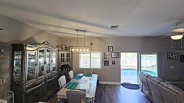 25631 Bruford Blvd, Land O Lakes, FL 34639 - dining area with dark wood-style flooring, ceiling fan, a chandelier, and baseboards