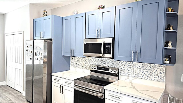 25631 Bruford Blvd, Land O Lakes, FL 34639 - kitchen featuring stainless steel appliances, open shelves, light stone counters, and tasteful backsplash