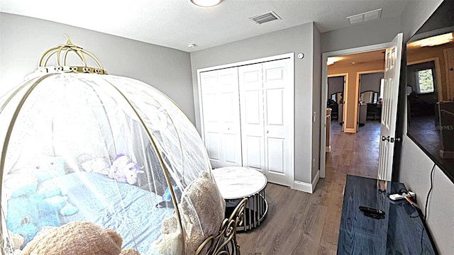 25631 Bruford Blvd, Land O Lakes, FL 34639 - bedroom featuring wood finished floors, a closet, and baseboards