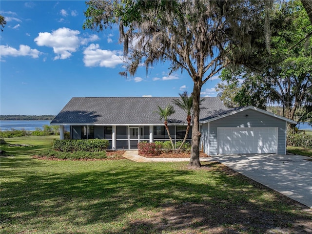 single story home with a shingled roof, concrete driveway, a front lawn, and a sunroom