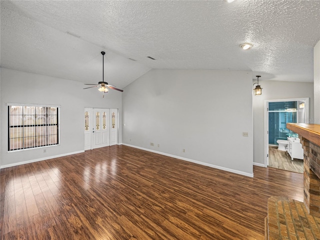 unfurnished living room featuring baseboards, lofted ceiling, wood finished floors, a textured ceiling, and a ceiling fan