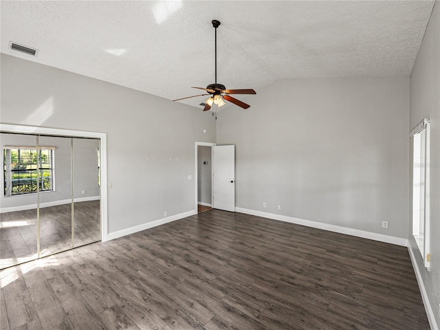 unfurnished bedroom featuring wood finished floors, baseboards, visible vents, high vaulted ceiling, and a textured ceiling