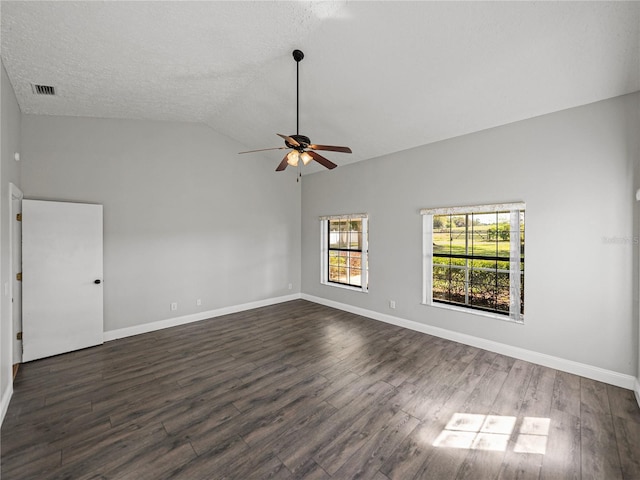 spare room with lofted ceiling, ceiling fan, and dark wood finished floors