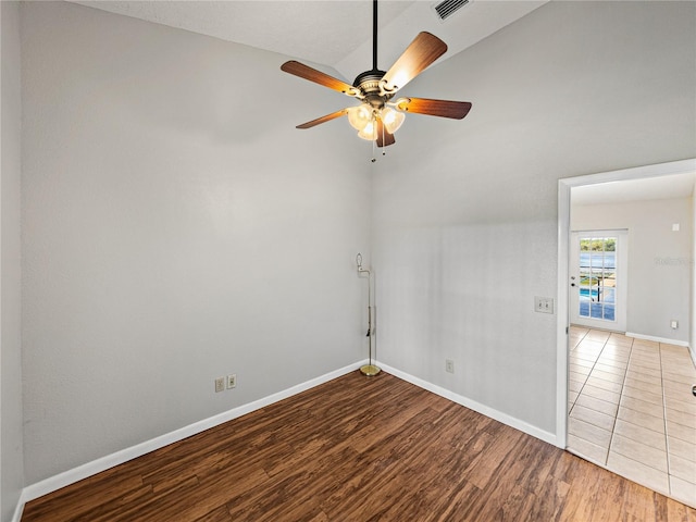 spare room featuring visible vents, baseboards, a ceiling fan, and wood finished floors