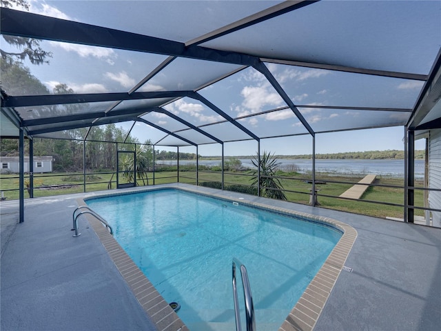 outdoor pool featuring a water view, a lawn, a patio, and a lanai