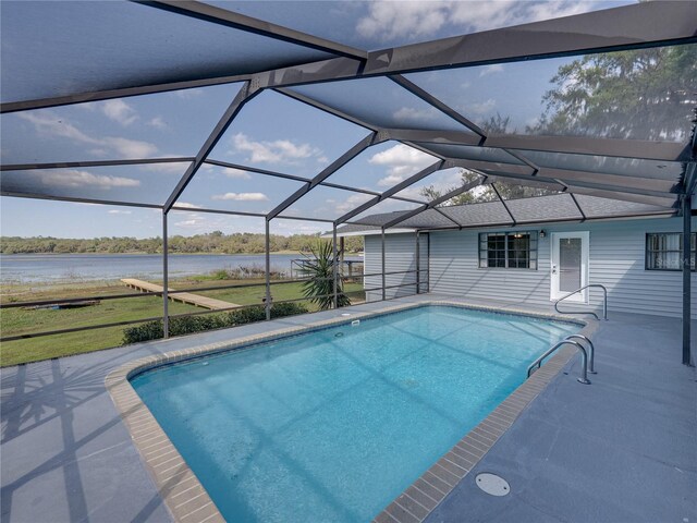 pool with a patio, a water view, and a lanai