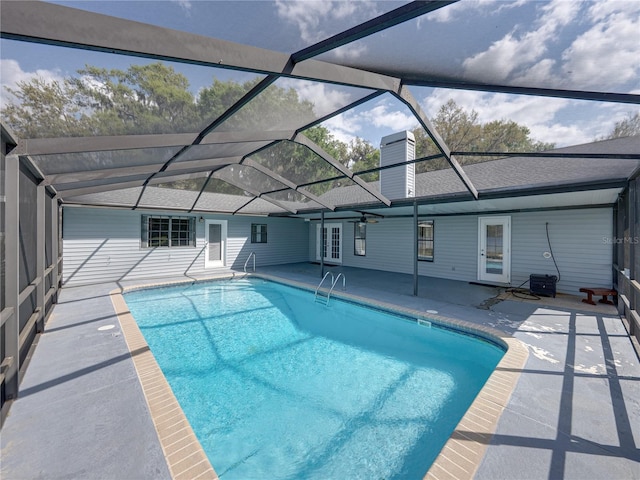 pool with french doors, a lanai, and a patio area