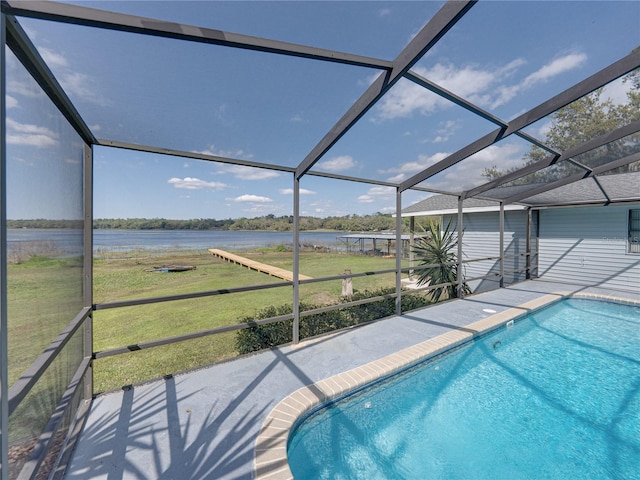 outdoor pool featuring a yard, a water view, a patio, and glass enclosure