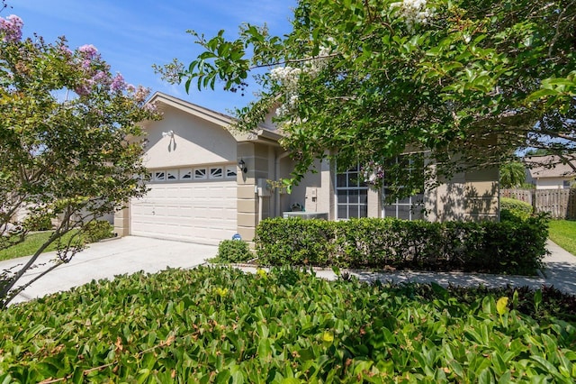2991 Covewood Pl, Clearwater, FL 33761 - view of front facade featuring an attached garage, driveway, and stucco siding