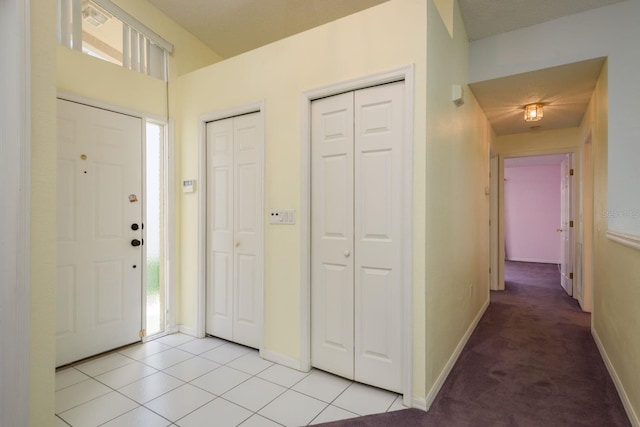 2991 Covewood Pl, Clearwater, FL 33761 - entryway featuring baseboards, light tile patterned floors, and light carpet