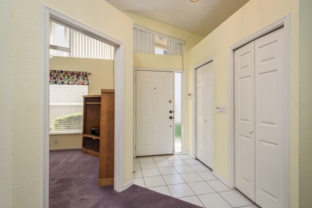 2991 Covewood Pl, Clearwater, FL 33761 - foyer featuring light carpet, baseboards, and light tile patterned floors