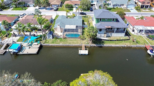 drone / aerial view with a residential view and a water view