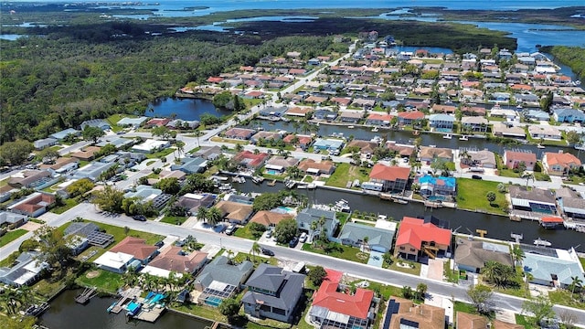 birds eye view of property with a residential view and a water view