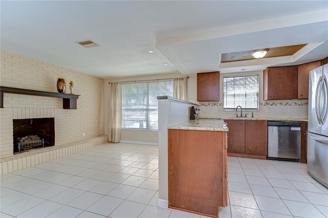 kitchen featuring light tile patterned floors, stainless steel appliances, visible vents, and light countertops